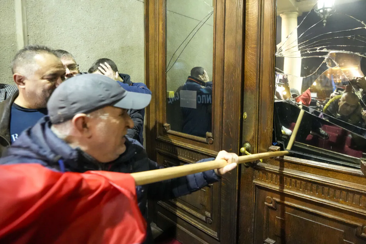 Opposition supporters attempt to enter the capital's city council building in protest of what election observers said were widespread vote irregularities during a general election last weekend in Belgrade, Serbia, on Dec. 24, 2023. (Darko Vojinovic/AP Photo)