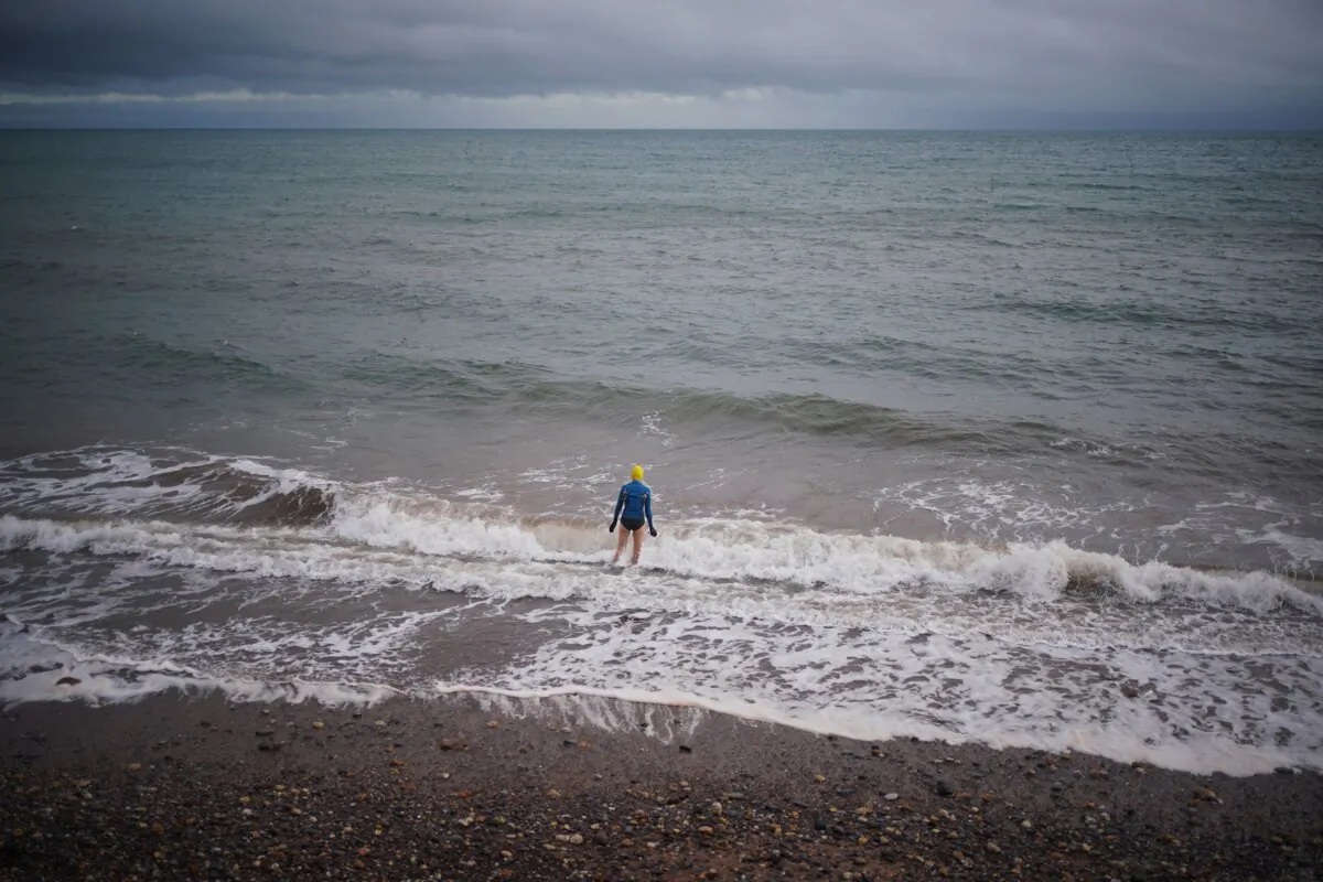 A swimmer in the sea in Dawlish Warren, south Devon on Christmas Eve 2023. (Yui Mok/PA)