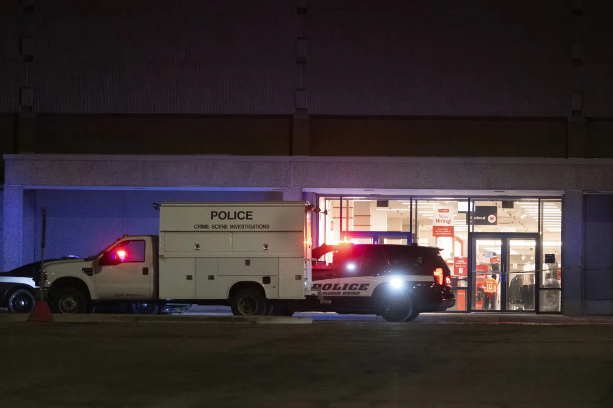 Colorado Springs Police Department investigators continue working the scene at Citadel Mall in Colorado Springs, Colo., late Christmas Eve after authorities said a fatal shooting occurred at the shopping center, on Dec. 24, 2023. (Jerilee Bennett/The Gazette via AP)