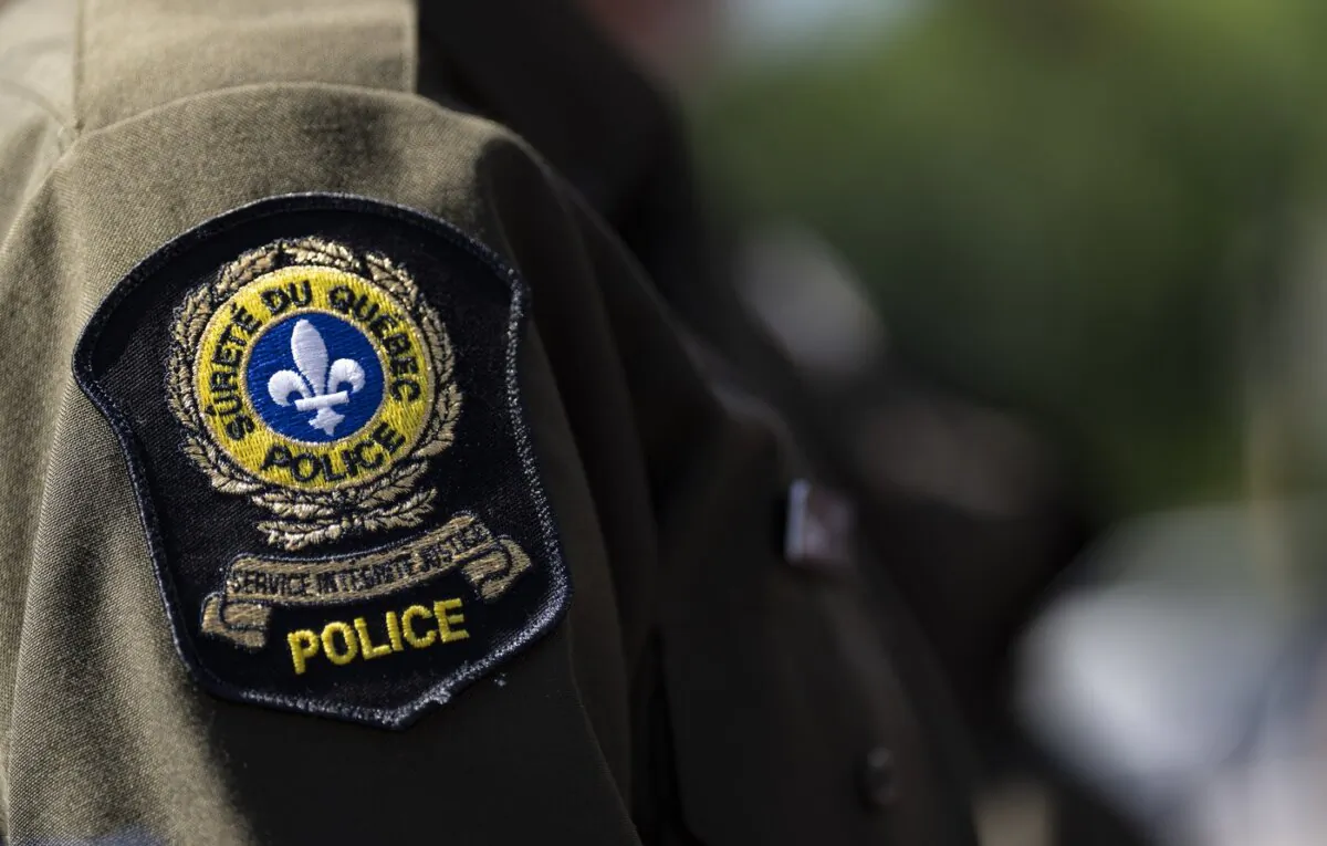 A Surete du Quebec emblem is seen on an officer’s uniform in Montreal on Aug. 22, 2023. (The Canadian Press/Christinne Muschi)