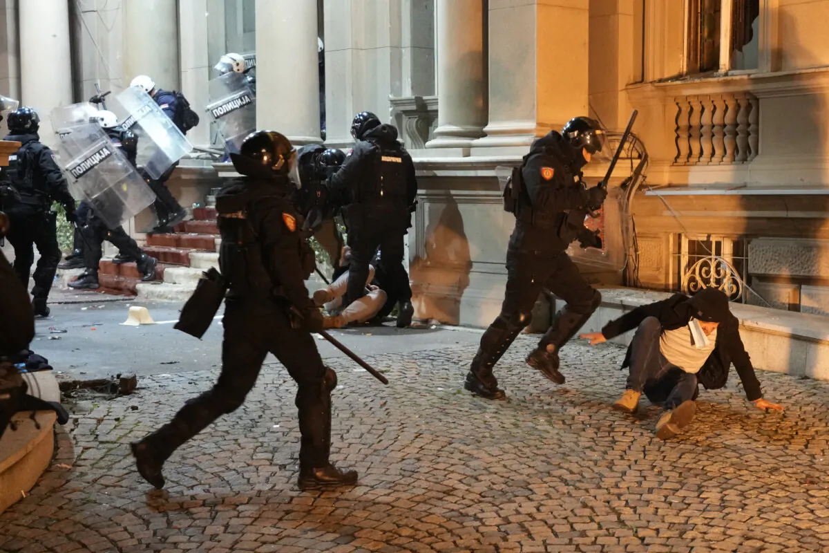 Protesters clash with anti-riot police in Belgrade, Serbia, on Dec. 24, 2023. (Darko Vojinovic/AP)