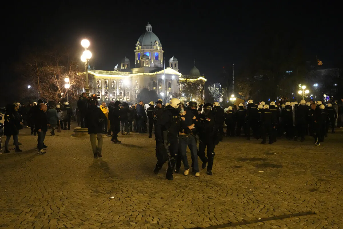 A protester is detained by gendarme in downtown Belgrade, Serbia, on Dec. 24, 2023. (Darko Vojinovic/AP Photo)