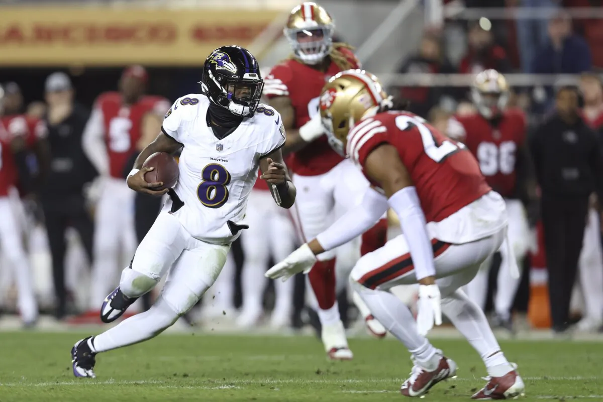 Baltimore Ravens quarterback Lamar Jackson (8) runs against the San Francisco 49ers during the first half of an NFL football game in Santa Clara, Calif., on Dec. 25, 2023. (Jed Jacobsohn/AP Photo)