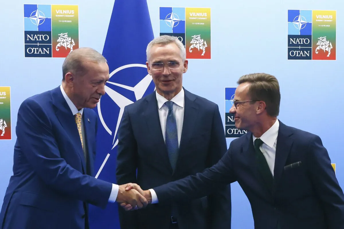 Turkey's President Recep Tayyip Erdogan (L) shakes hands with Sweden's Prime Minister Ulf Kristersson (R) as NATO Secretary General Jens Stoltenberg looks on prior to a meeting ahead of a NATO summit in Vilnius, Lithuania, on July 10, 2023. (Yves Herman/Pool Photo via AP)