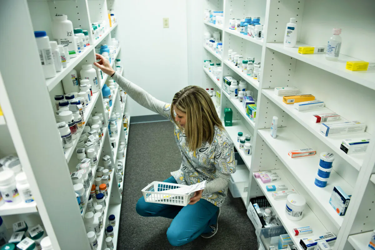 A staff member sorts through drugs while filling a prescription at the Clay-Battelle Community Health Center's pharmacy in Blacksville, W. Va., on March 21, 2017.
(Brendan Smialowski/AFP via Getty Images)
