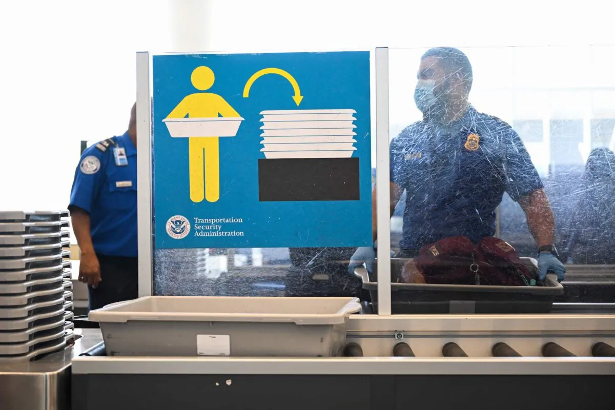 A Transportation Security Administration (TSA) agent screens carry-on baggage at Los Angeles International Airport on Aug. 10, 2022. (Patrick T. Fallon/AFP via Getty Images)