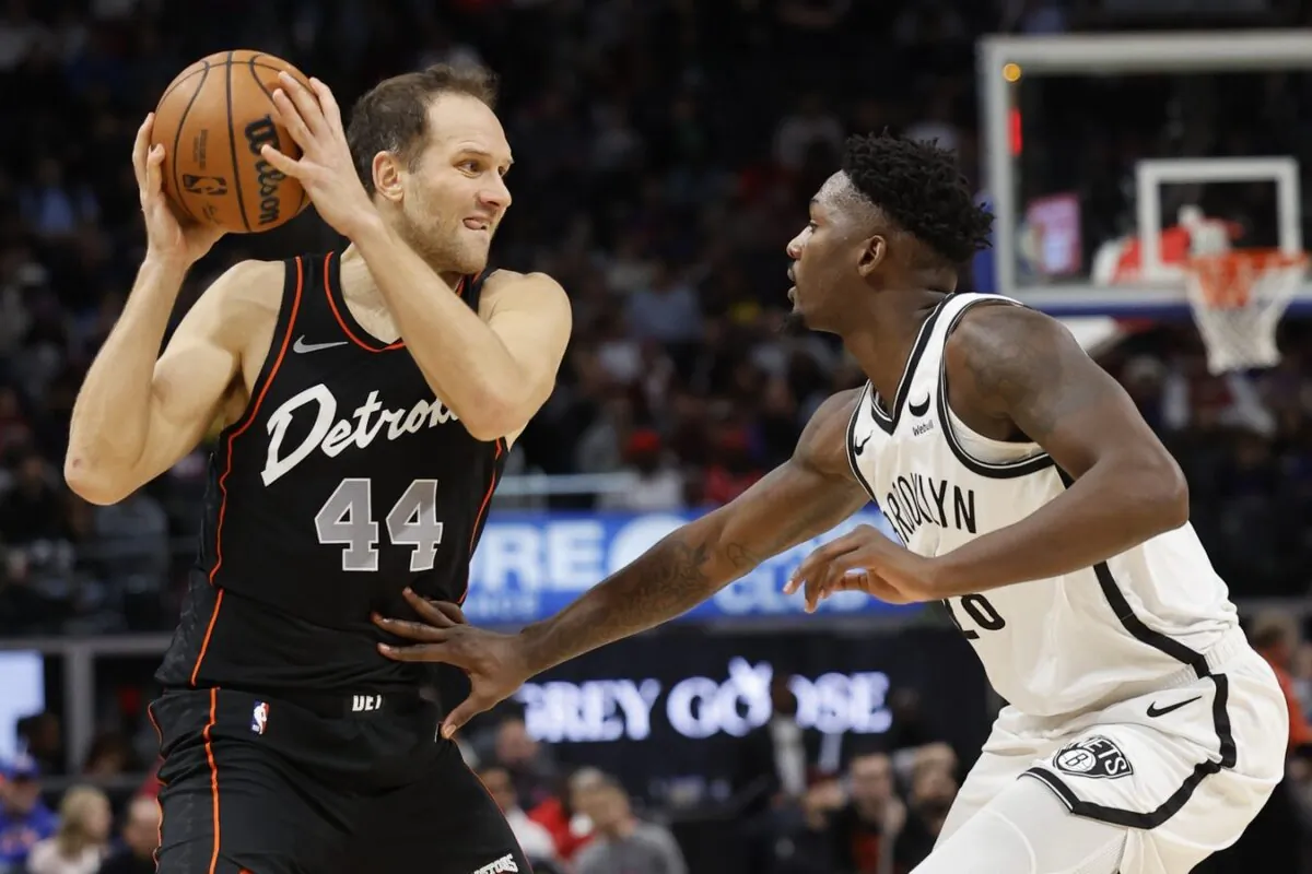 Detroit Pistons forward Bojan Bogdanovic (44) is defended by Brooklyn Nets forward Dorian Finney-Smith (28) in the first half in Detroit on Dec. 26, 2023. (Rick Osentoski/USA TODAY Sports via Field Level Media)