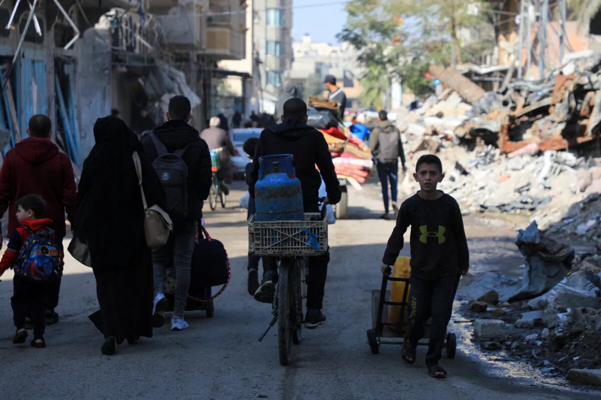 Palestinians flee their houses, after they were ordered by the Israeli army to evacuate the area, in Bureij in the central Gaza Strip, on Dec. 26, 2023. (Mohammed Al-Masri/Reuters)