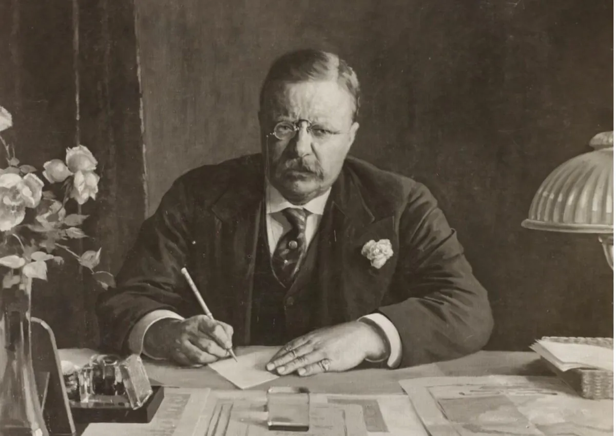 A painting of Theodore Roosevelt at his desk writing the Panama Canal Zone document, circa 1922. (Public Domain)