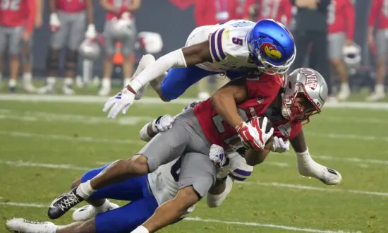 Bean Throws for 6 TDs, Kansas Overcomes Flags to Beat UNLV 49–36 in Guaranteed Rate Bowl