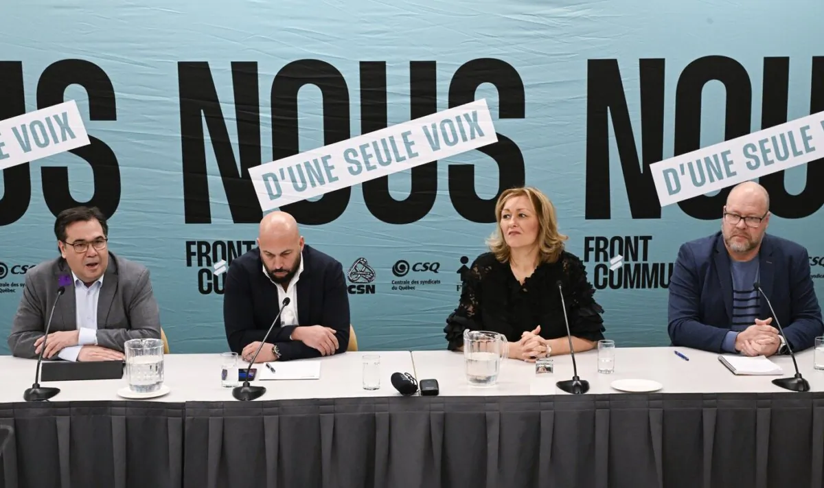 (L-R) François Hénault of the CSN, Éric Gingras of the CSQ, Magali Picard of the FTQ and Robert Comeau of the APTS speak at a news conference in Quebec City on Dec. 20, 2023. (The Canadian Press/Jacques Boissinot)
