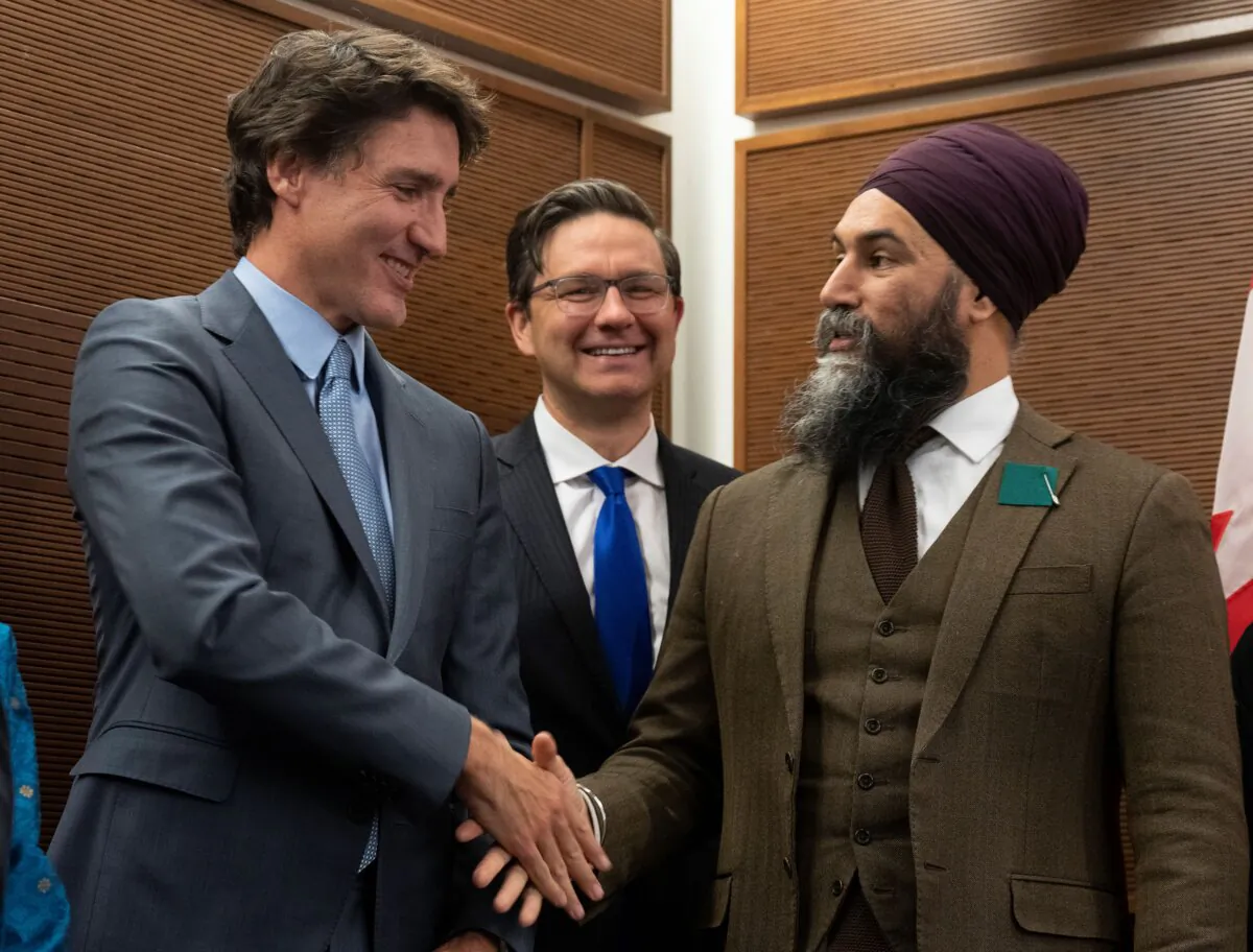 Prime Minister Justin Trudeau shakes hands with NDP Leader Jagmeet Singh as Conservative Leader Pierre Poilievre looks on, at an event in Ottawa on Jan. 30, 2023. (The Canadian Press/Adrian Wyld)