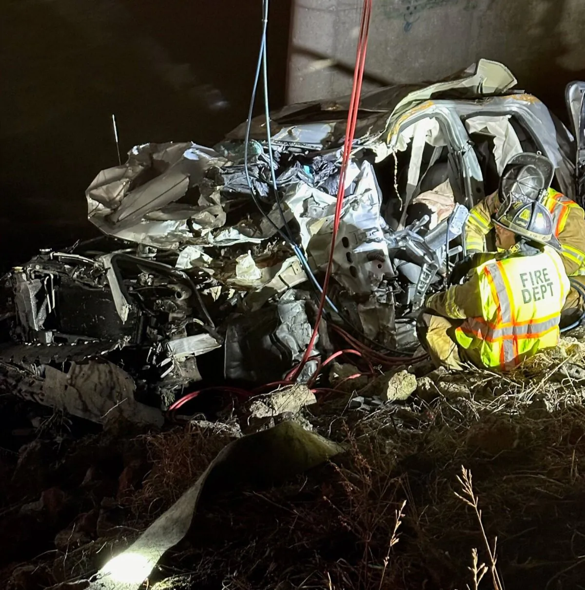 Police rescue a man after finding his damaged vehicle along Interstate 94 near Portage, Ind., on Dec. 26, 2023. (Indiana State Police via AP)