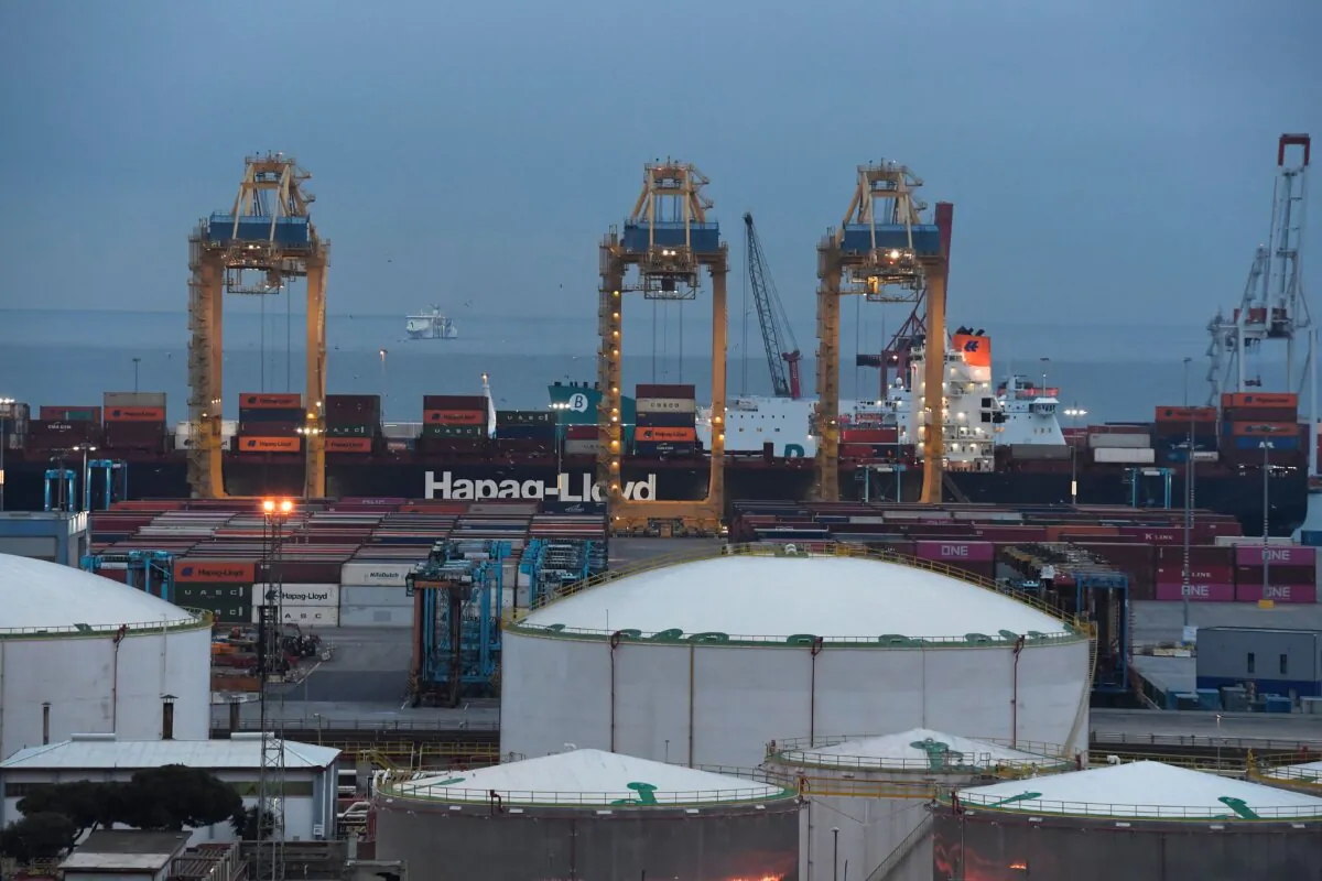 Storage tanks and a container ship of Hapag-Lloyd AG German sea carrier company at the port of Barcelona, Spain, on Dec. 11, 2022. (Pau Barrena/AFP via Getty Images)
