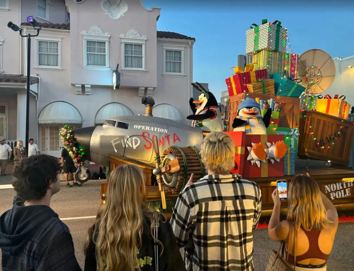 Universal Studios visitors watch the beginning of the theme park’s holiday parade and a ‘Madagascar’ themed float. (Dewayne Bevil/Orlando Sentinel/TNS)