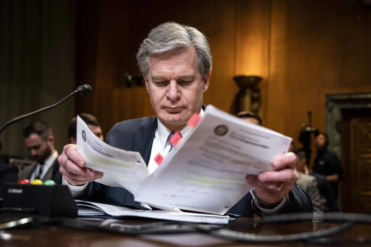 FBI Director Christopher Wray looks over notes as he arrives for a hearing on Capitol Hill in Washington, on May 10, 2023. (Drew Angerer/Getty Images)