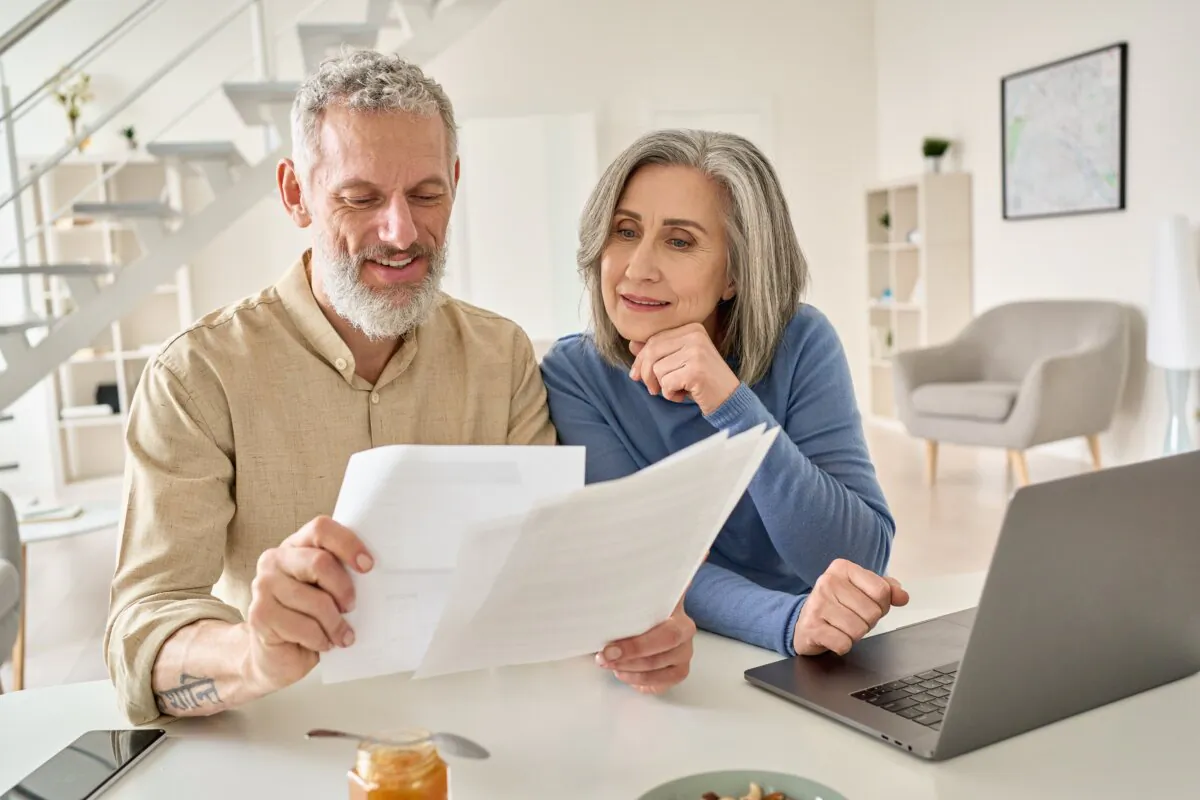 Senior couple works online on the side business they started after retirement. (Ground Picture/Shutterstock)