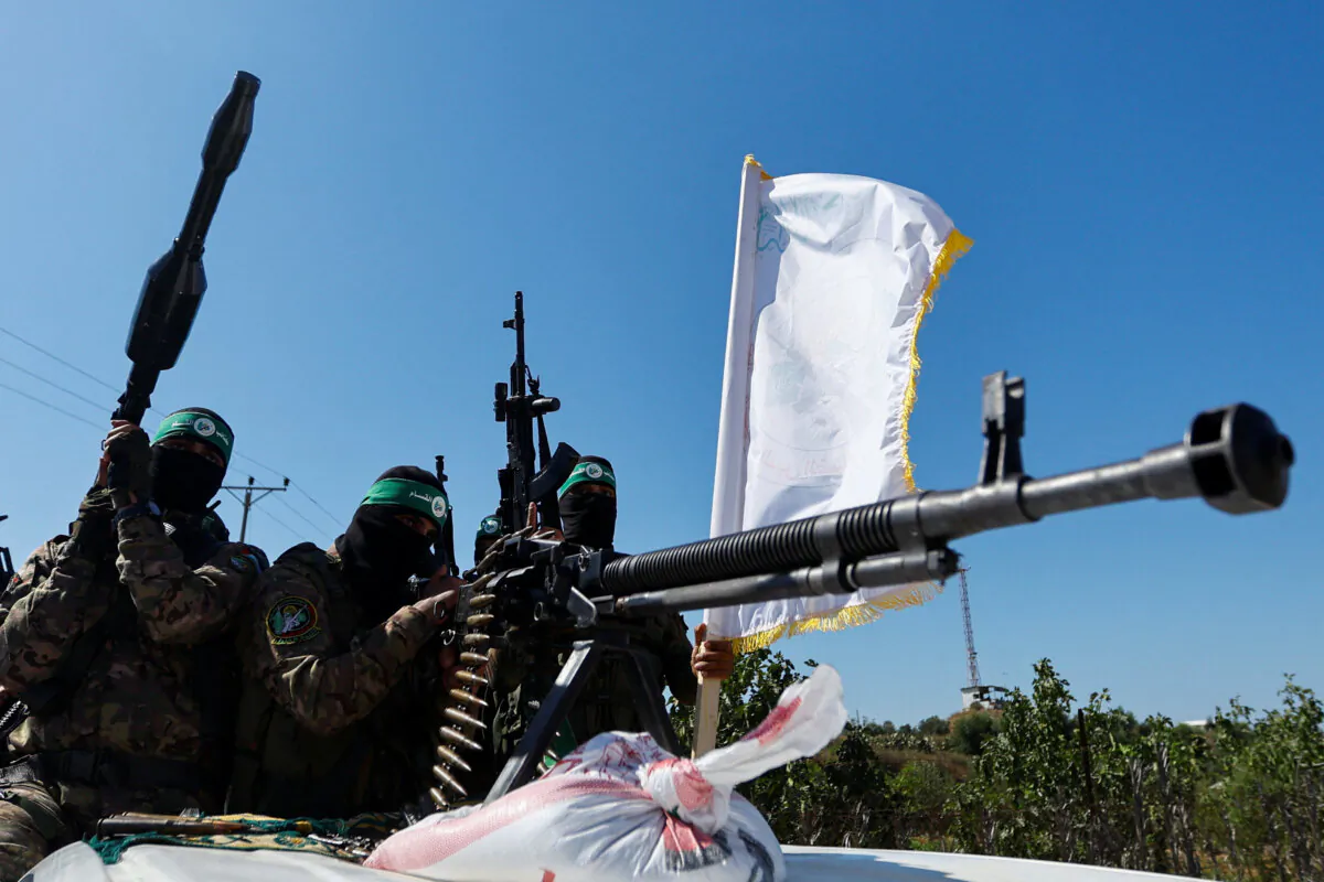 Terrorists from the armed wing of Hamas take part in a military parade to mark the anniversary of the 2014 war with Israel, near the border in the central Gaza Strip, on July 19, 2023. (Ibraheem Abu Mustafa/Reuters)
