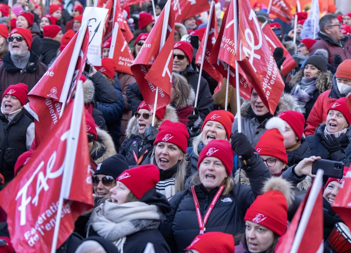 Striking teachers and their supporters hold a rally in front of Premier François Legault's office in Montreal on Dec. 22, 2023. (The Canadian Press/Ryan Remiorz)