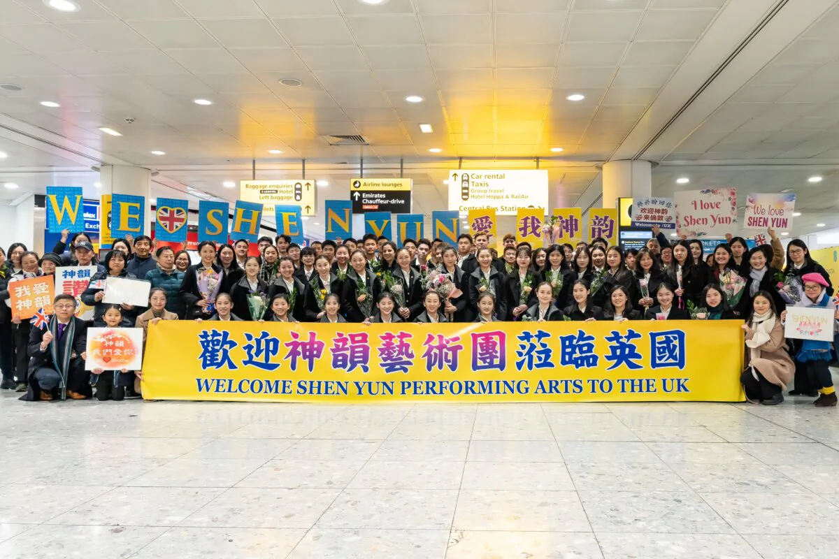 Artists of Shen Yun New Era Company pose for photo at the Heathrow airport in London on Dec. 28, 2023 (Roger Luo/The Epoch Times)