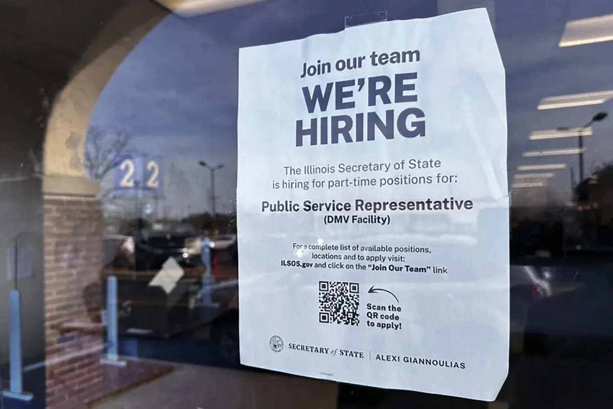 A hiring sign is displayed at the Department of Motor Vehicles office in Deerfield, Ill., on Dec.12, 2023. (Nam Y. Huh/AP Photo)