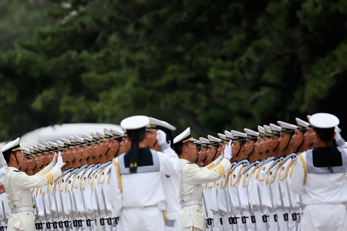 Chinese People's Liberation Army Navy soldiers and officers attend a ceremony in Beijing on Sept. 16, 2013. (Feng Li/Getty Images)