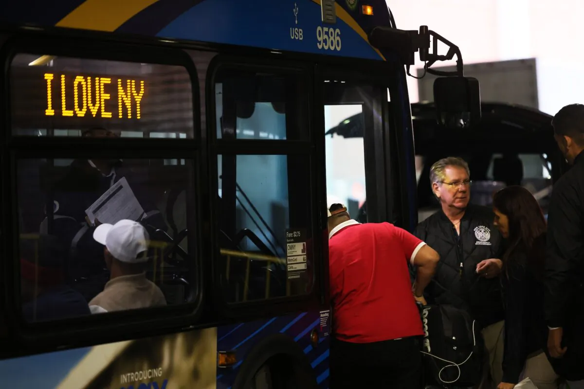 Illegal immigrants board a bus en-route to a shelter at Port Authority Bus Terminal, in New York City on May 18, 2023. (Michael M. Santiago/Getty Images)
