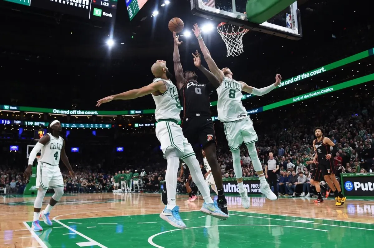 Boston Celtics guard Derrick White (9) Detroit Pistons center Jalen Duren (0) and center Kristaps Porzingis (8) battle for a rebound during overtime at TD Garden in Boston on Dec. 28, 2023. (Bob DeChiara/USA TODAY Sports via Field Level Media)