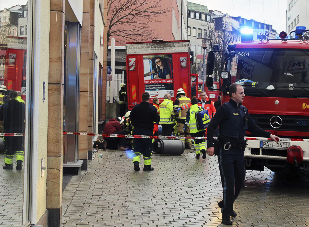 Fire and rescue services stand at the scene of a car accident in the city center in Passau, Germany, on Dec. 29, 2023. (Zema Medien/dpa via AP)