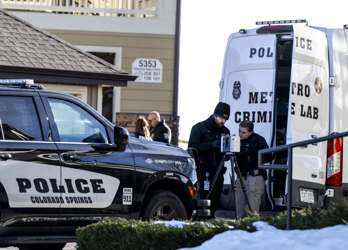 Colorado Springs Police Department investigators and officers work on the scene after responding to a 911 call reporting a burglary where they found children dead inside a condo of the Palomino Ranch Point complex in Colorado Springs, Colo., on Dec. 19, 2023. (Parker Seibold/The Gazette via AP)