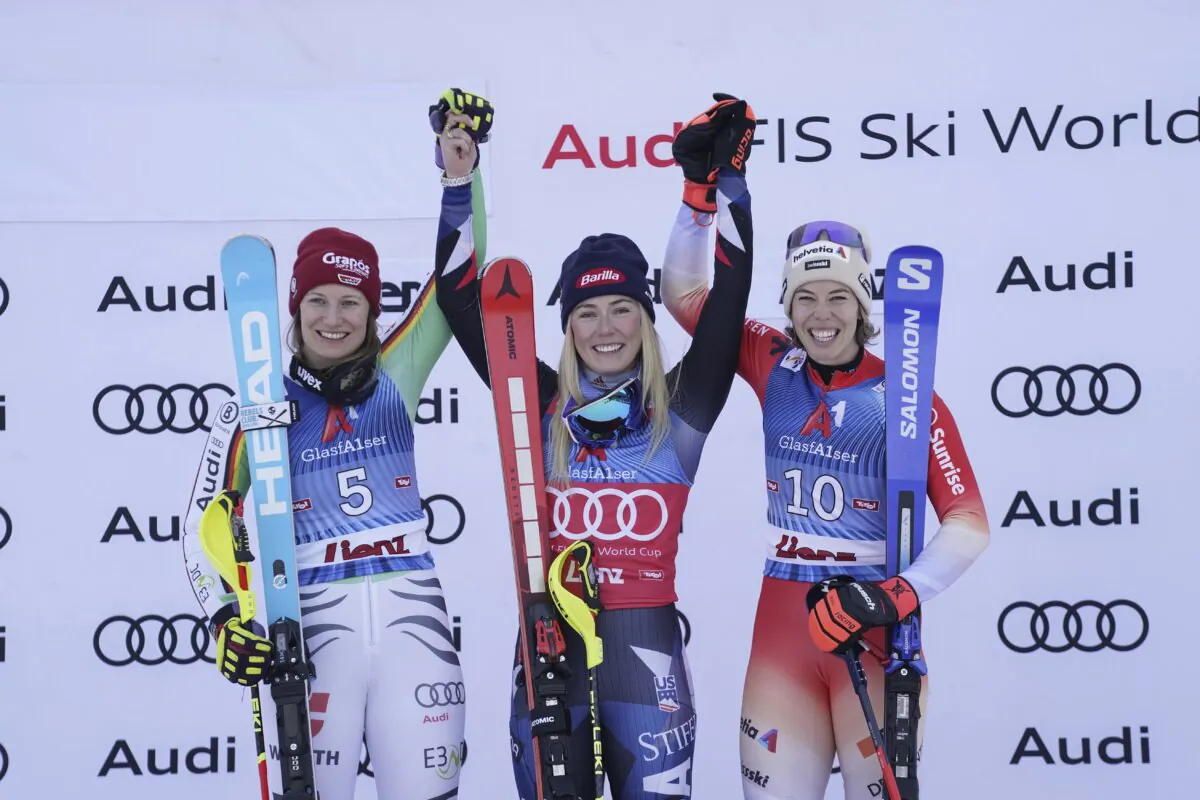 From left, second placed Germany's Lena Duerr, the winner United States' Mikaela Shiffrin and third placed Switzerland's Michelle Gisin celebrate after an alpine ski, women's World Cup slalom race, in Lienz, Austria, on Dec. 29, 2023. (Giovanni Auletta/AP Photo)