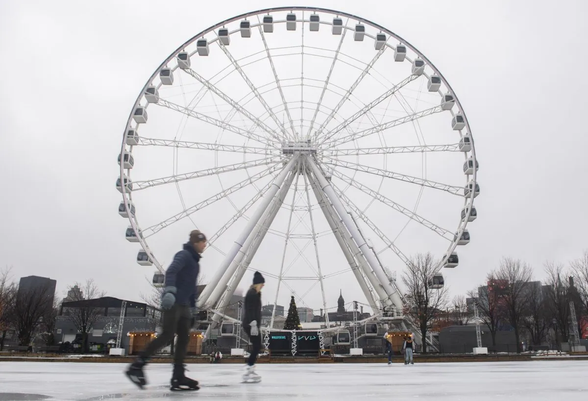People skate on the Old Port skating rink on New Year's Day in Montreal, on Jan. 1, 2023. (The Canadian Press/Graham Hughes)