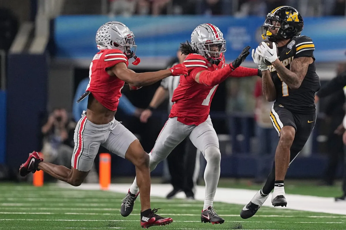 Theo Wease Jr. (1) of the Missouri Tigers catches a pass against Jordan Hancock (7) of the Ohio State Buckeyes for a first down during the fourth quarter in the Goodyear Cotton Bowl in Arlington, Texas, on Dec. 29, 2023. (Sam Hodde/Getty Images)