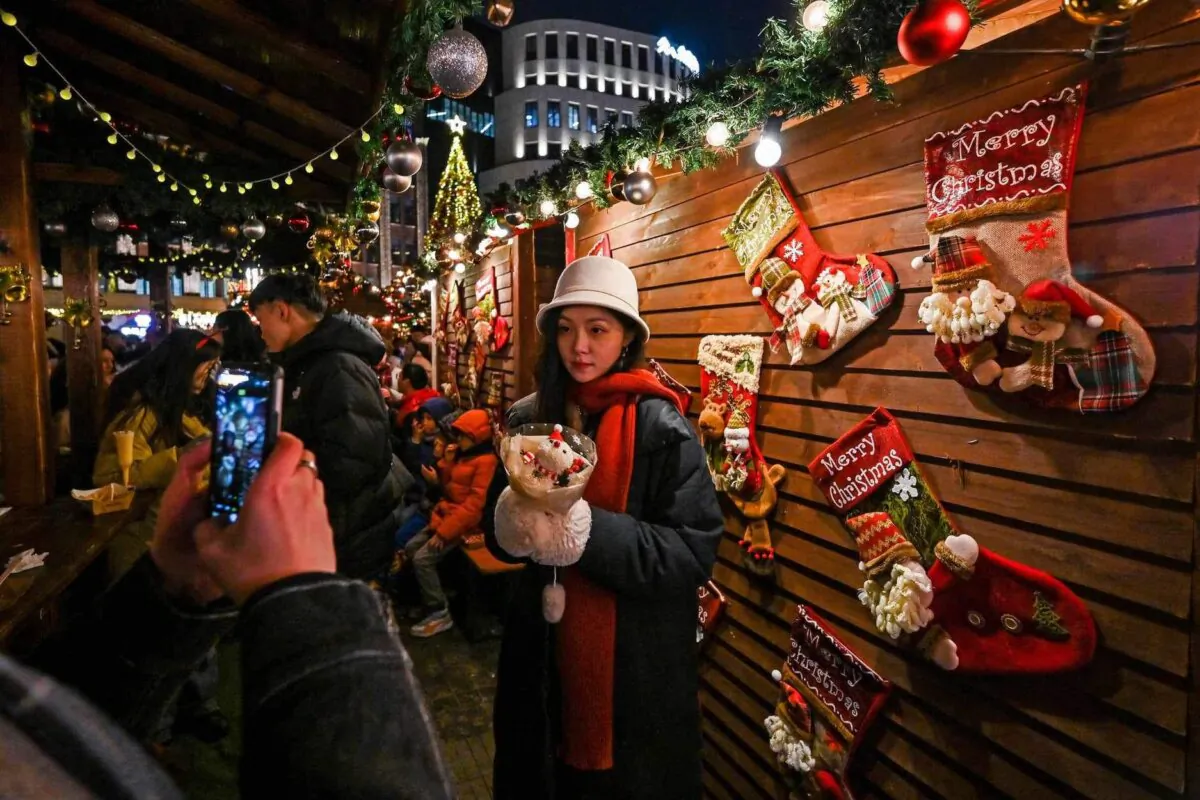 People visit a Christmas market in the Huangpu district in Shanghai on Dec. 23, 2023. (Hector Retamal / AFP via Getty Images)
