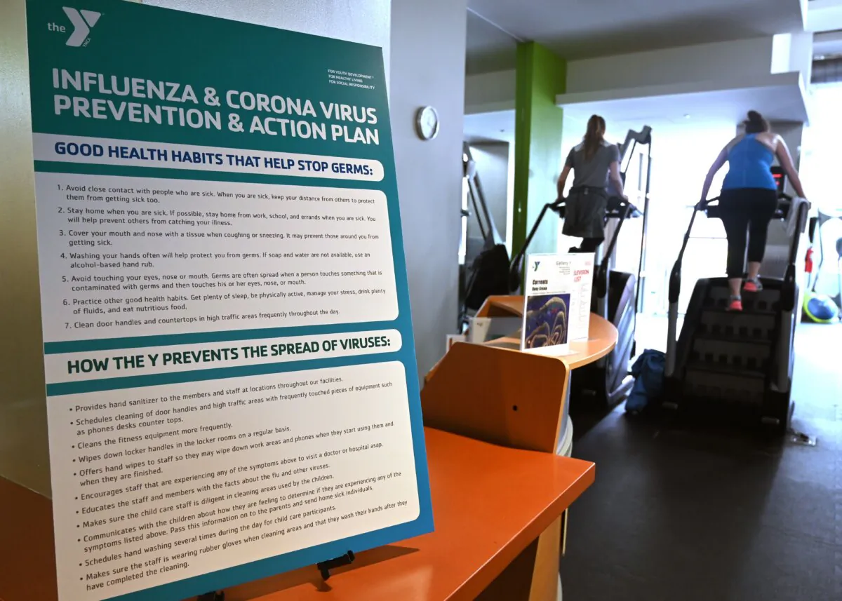 A poster informs guests about health habits as people exercise at a YMCA community center and gym in a file photo. (Eva Hambach/AFP via Getty Images)