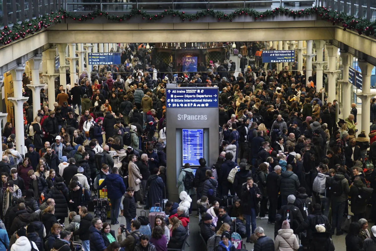 Passengers wait on the concourse at the entrance to the Eurostar in St Pancras International station, central London, on Dec. 30, 2023. (James Manning/PA via AP)