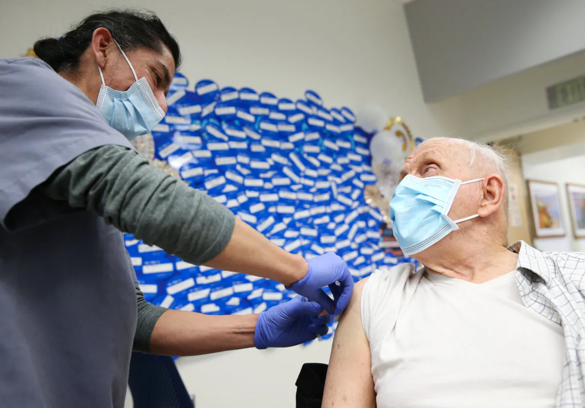 A certified medical assistant applies a Band-Aid after administering a vaccine at Harbor-UCLA Medical Center in Torrance, Calif., on Jan. 21, 2021. (Mario Tama/Getty Images)