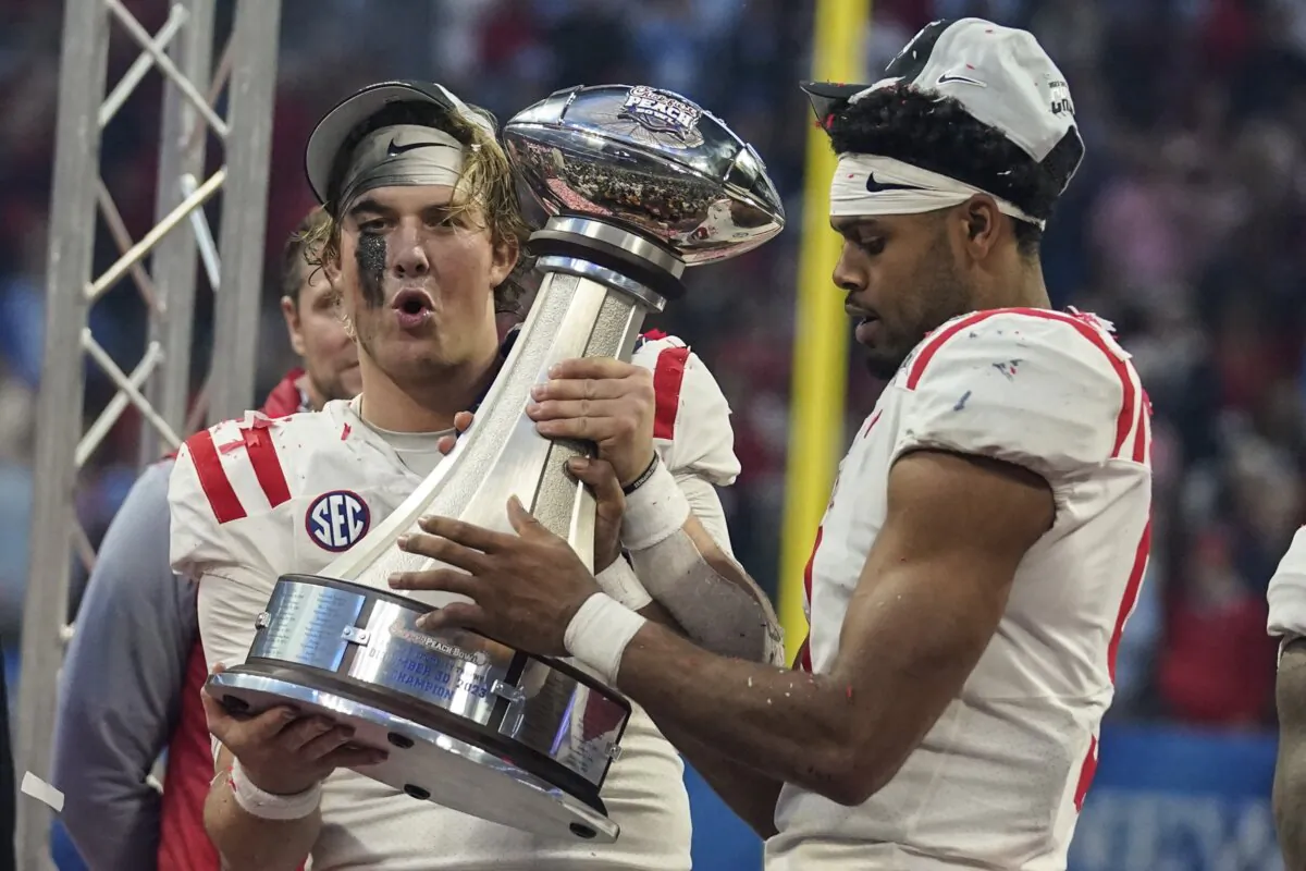 Mississippi celebrates with the Championship trophy after the Peach Bowl NCAA college football game between Penn State and Mississippi in Atlanta on Dec. 30, 2023. (Brynn Anderson/AP Photo)