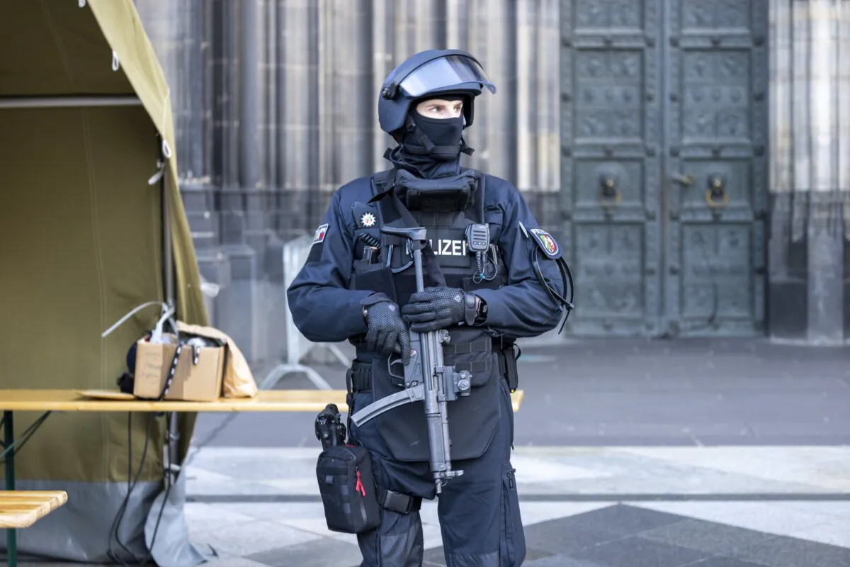 A police officer guards the Cologne Cathedral in Cologne, Germany, on Dec. 31, 2023. (Thomas Banneyer/dpa via AP)
