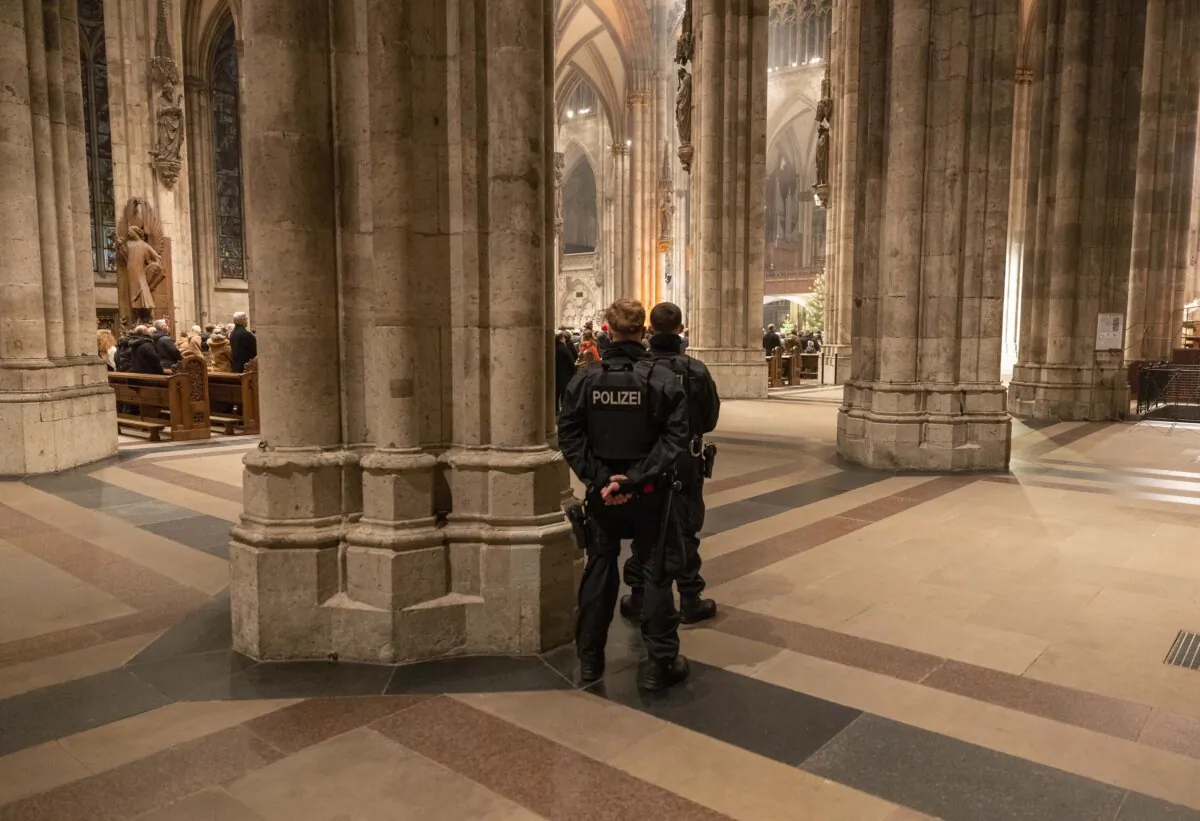 Police officers secure the Cologne Cathedral during the end-of-year pontifical mass in Cologne, Germany, on Dec. 31, 2023. (Thomas Banneyer/dpa via AP)