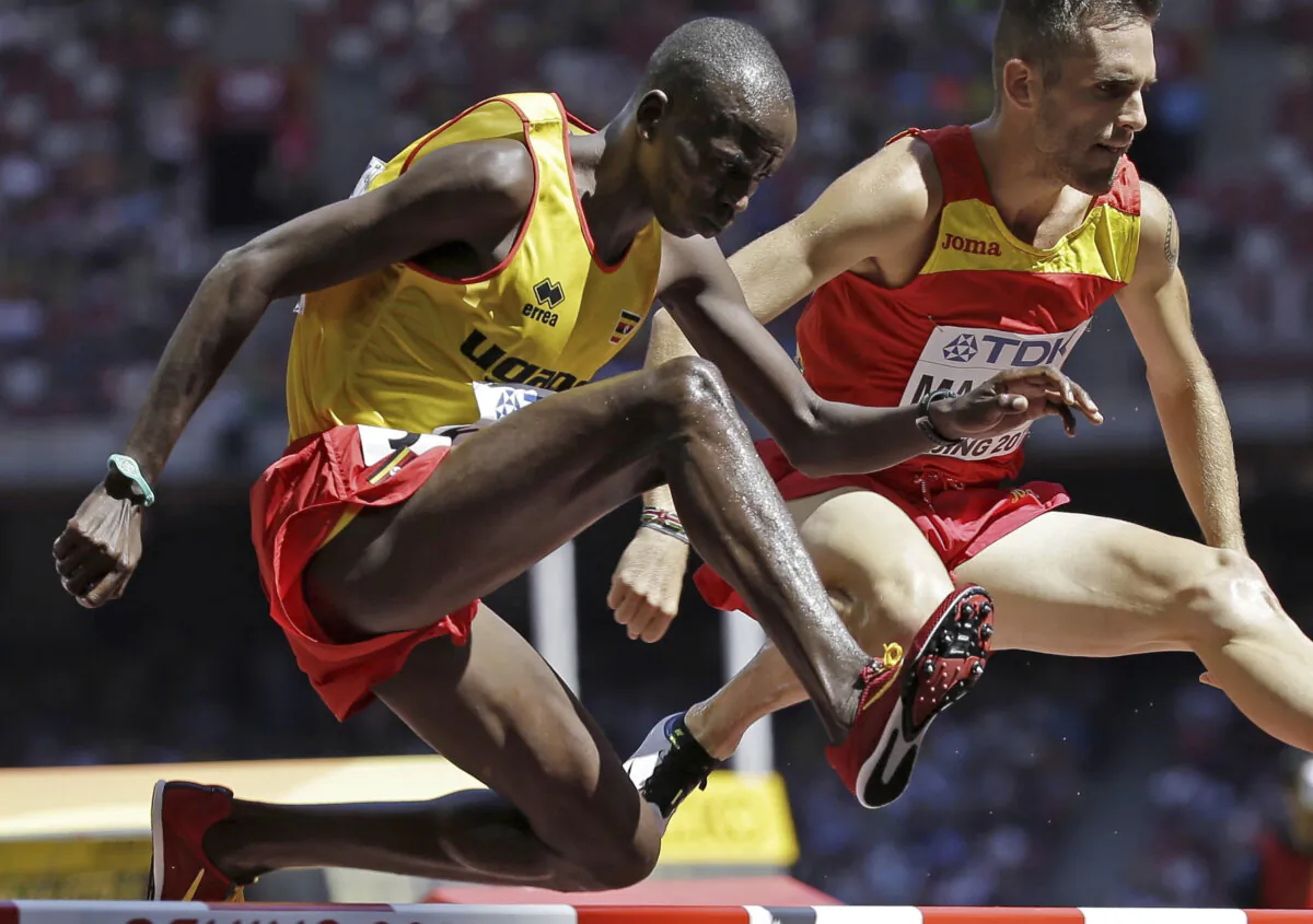 Uganda's Benjamin Kiplagat (front) competes in round one of the men's 3000m steeplechase during the World Athletic Championships at the Bird's Nest stadium in Beijing on Aug. 22, 2015. (David J. Phillip/AP Photo)