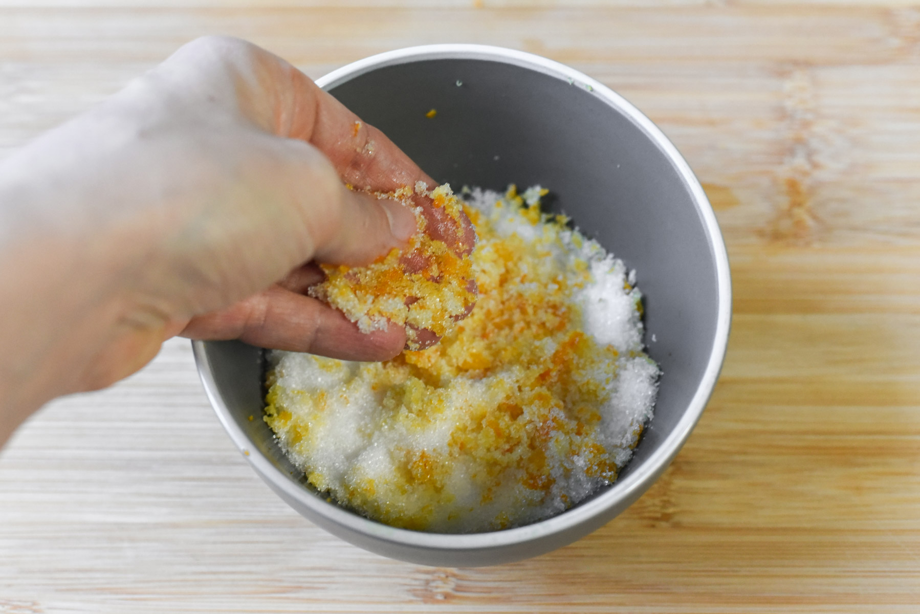 Rub the citrus zest into the sugar to release its fragrance. (Audrey Le Goff)