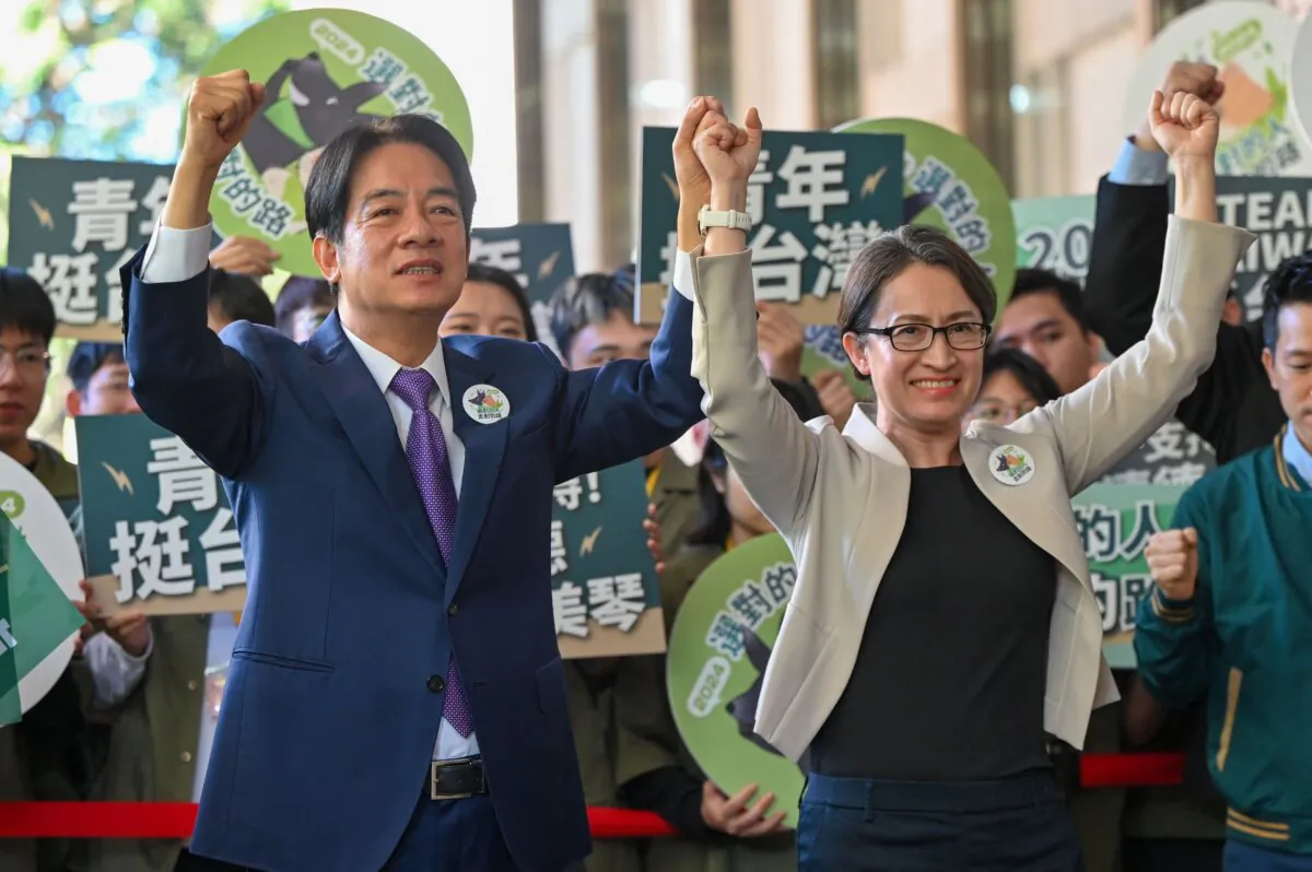 Taiwan presidential candidate Lai Ching-te (L) and his running mate Hsiao Bi-khim (R), from the ruling Democratic Progressive Party (DPP), gesture in front of supporters after they registered running for the 2024 presidential elections in Taipei on Nov. 21, 2023. (Sam Yeh/AFP via Getty Images)