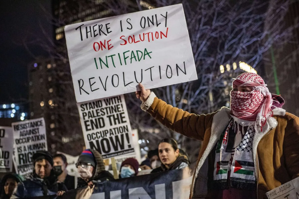 Pro-Palestinian demonstrators hold placards as they march in Boston, Massachusetts, on Dec. 31, 2023. (Joseph Prezioso/AFP via Getty Images)