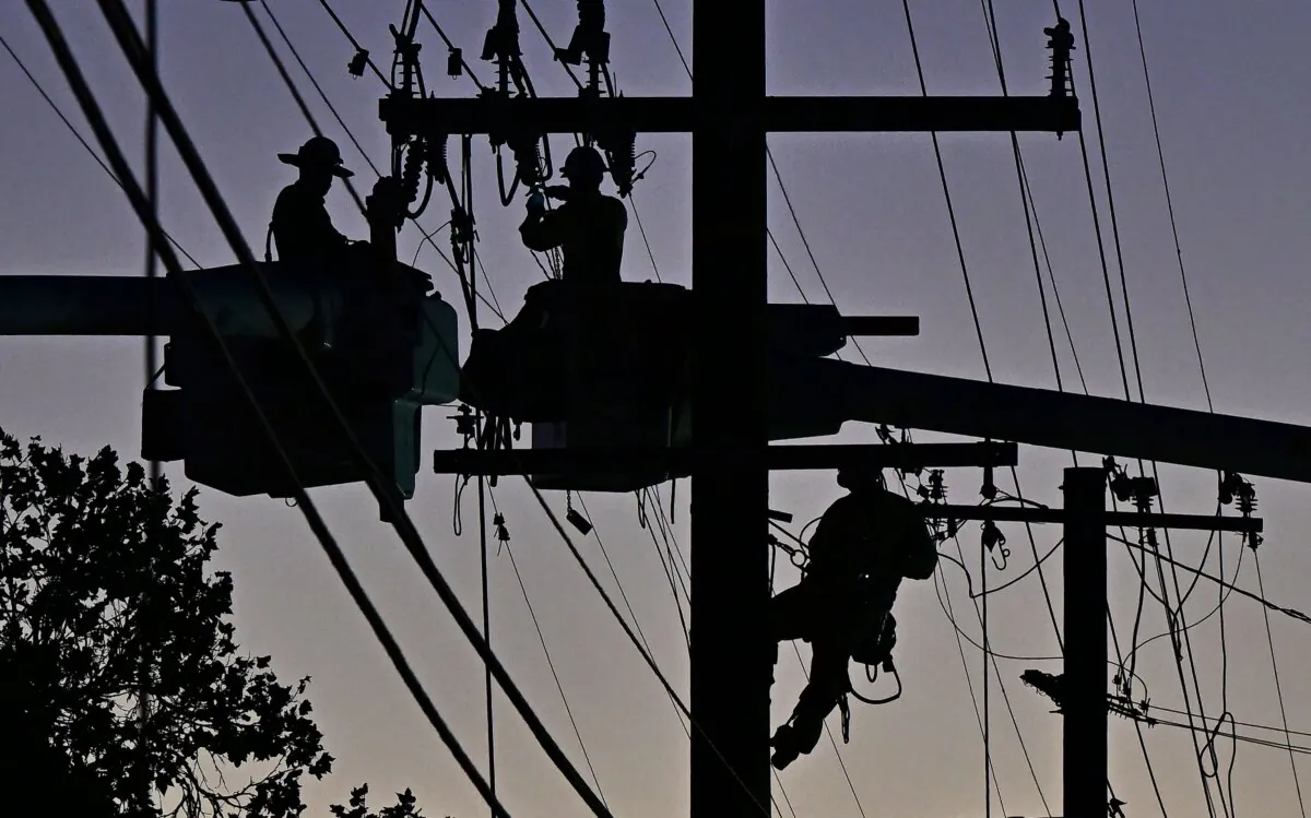 Workers replace power lines in Monterey Park, Calif., on Oct. 6, 2023. (Frederic J. Brown/AFP via Getty Images)