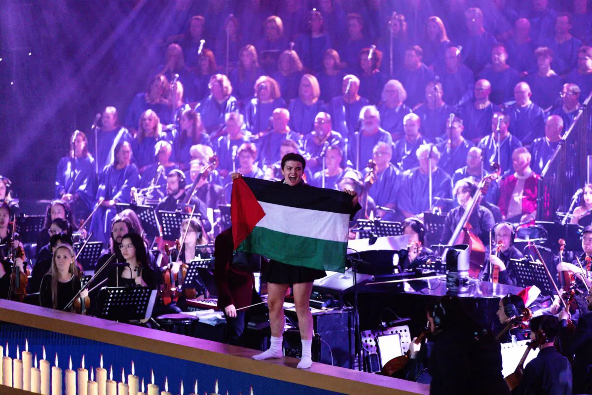Pro-Palestine protesters interrupt the Carols by Candlelight concert at the Sidney Myer Music Bowl in Melbourne, Sunday, Dec. 24, 2023. (Diego Fedele/AAP)