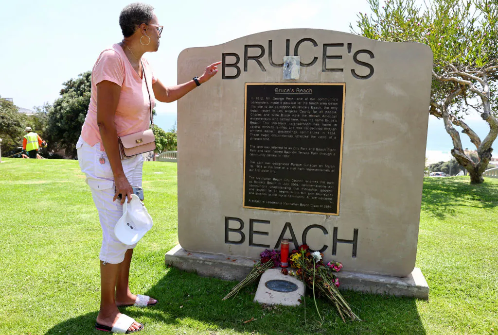Lois Bruce Johnson, a Bruce family descendant, views a plaque marking Bruce's Beach in Manhattan Beach, Calif., on June 29, 2022. (Mario Tama/Getty Images)