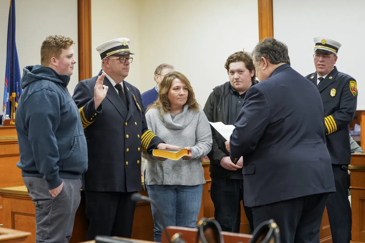 Robert Brady, surrounded by family members, was sworn in as fire chief of the City of Middletown by Mayor Joseph DeStefano at city hall in Middletown, N.Y., on Jan. 2, 2024. (Cara Ding/The Epoch Times)