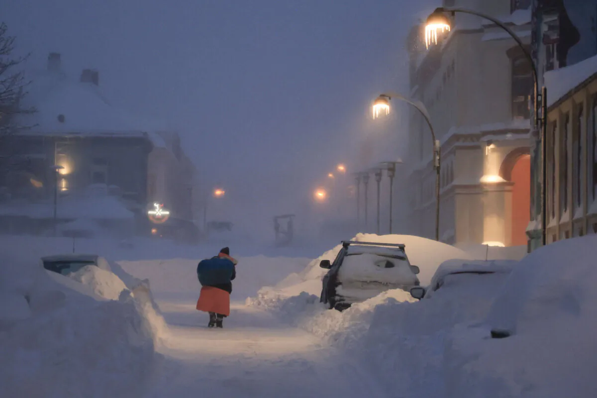 People fight their way through the snowstorm in Kristiansand, Norway, on Jan. 3, 2024. (Tor Erik Schroder/NTB Scanpix via AP)