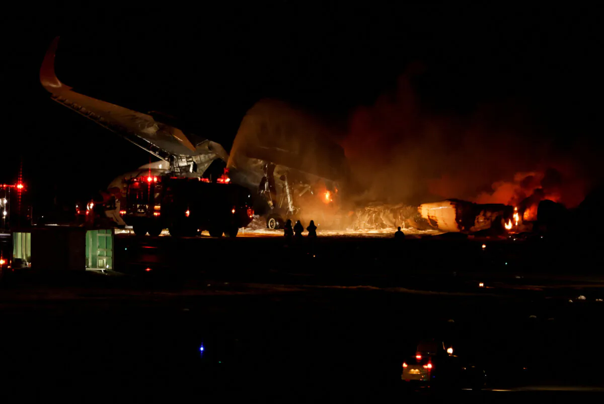Firefighters work on a burning Japan Airlines' A350 airplane at Haneda International Airport in Tokyo on Jan. 2, 2024. (Issei Kato/Reuters)